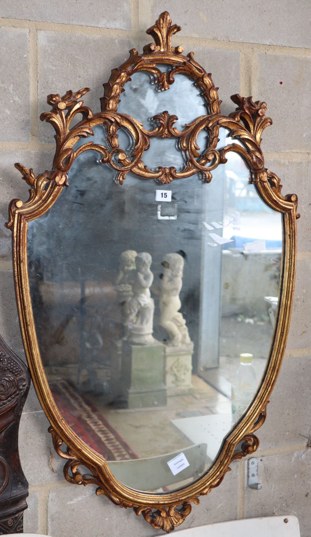 A reproduction gilt framed shield shaped wall mirror, W.62cm, H.106cm